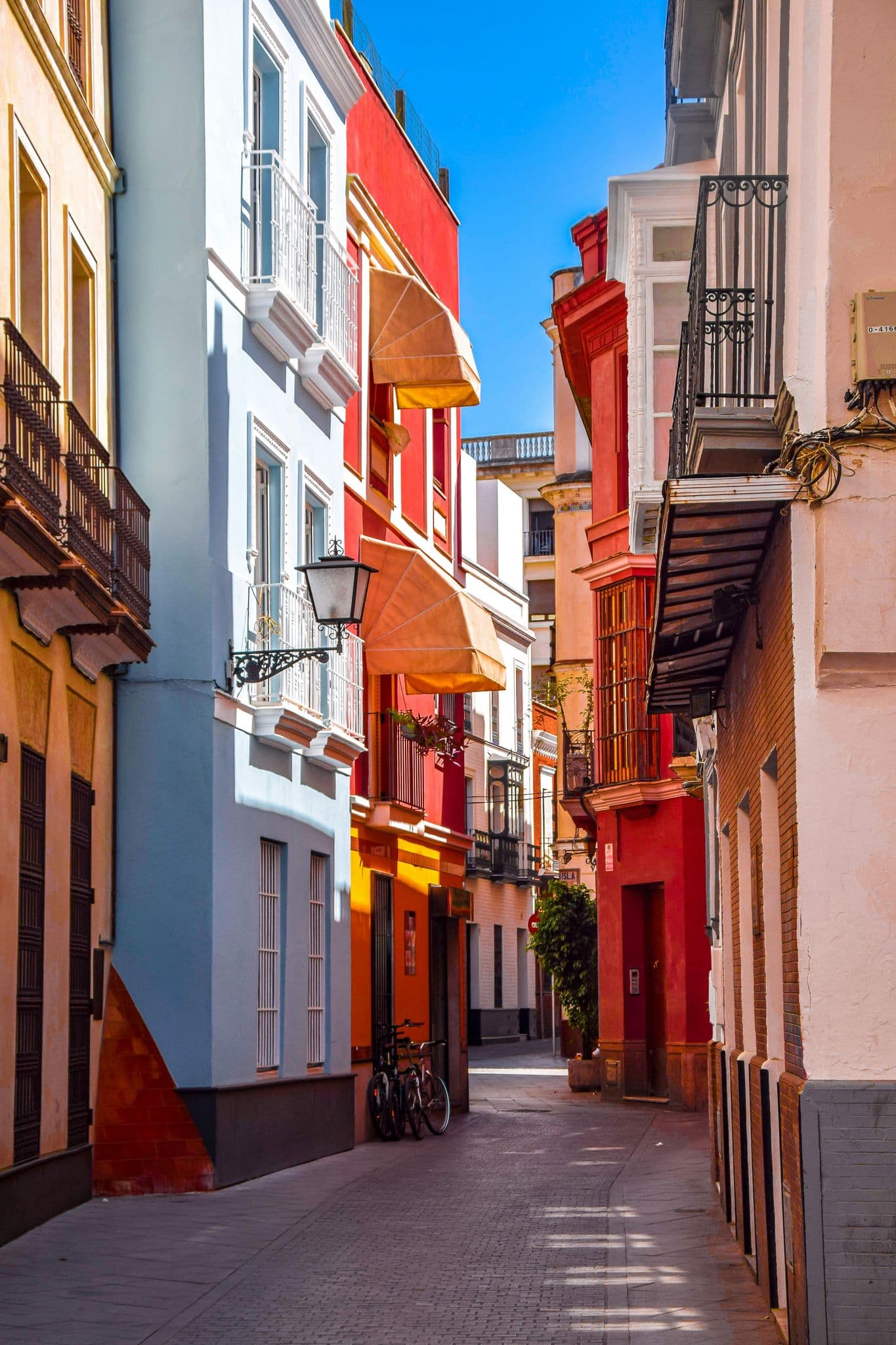 a narrow city street lined with tall buildings