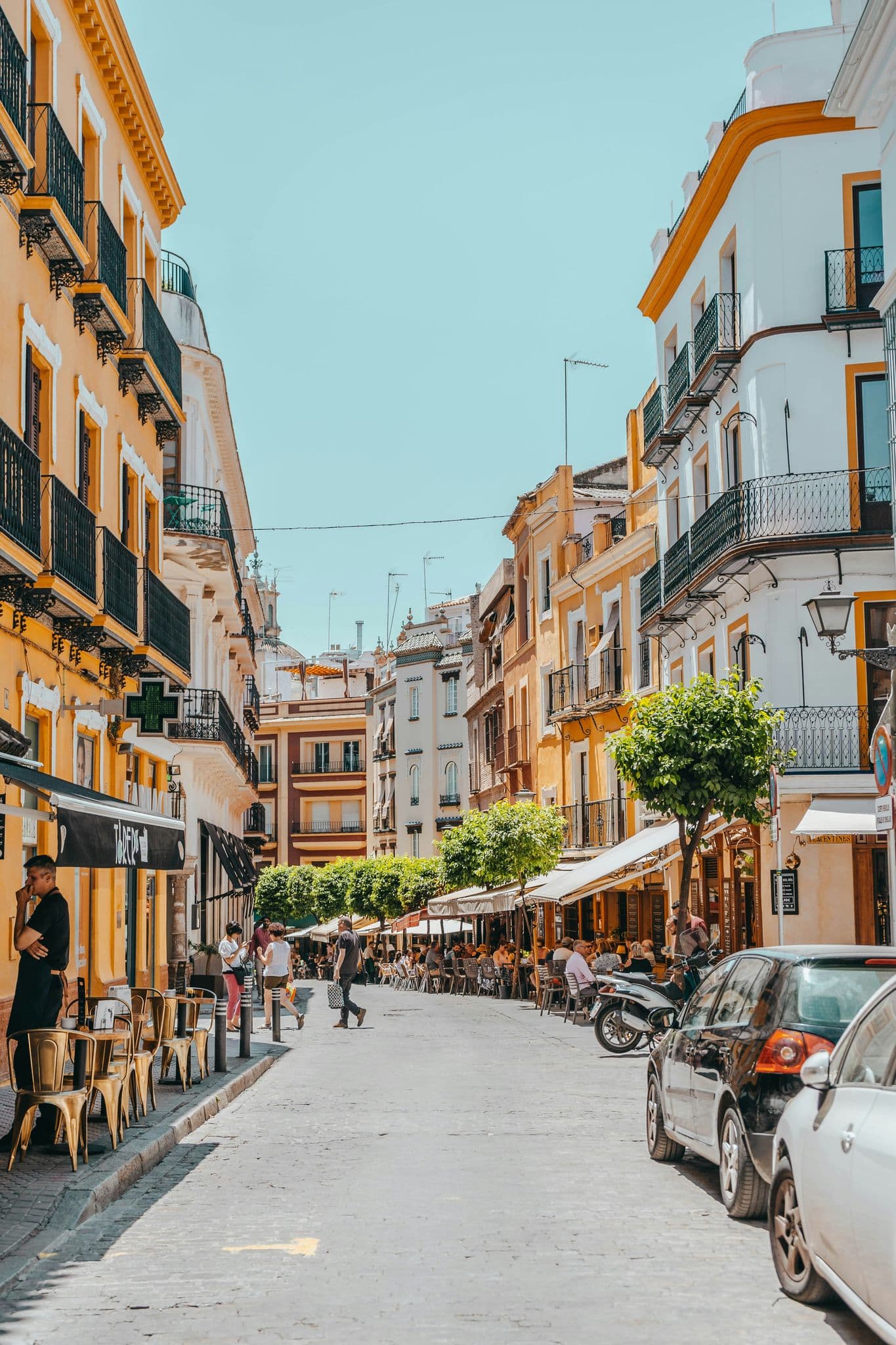 people walking between buildings during daytime